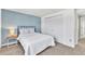 Bedroom with closet, full size bed, and accent wall at 7707 S Curtice Way # D, Littleton, CO 80120