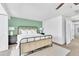 Bright bedroom features a cozy bed, ceiling fan, white walls, and a windowed alcove perfect for relaxing at 7707 S Curtice Way # D, Littleton, CO 80120
