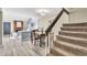 Inviting dining room with hardwood floors, a dining table, brick fireplace and staircase with carpeted steps at 7707 S Curtice Way # D, Littleton, CO 80120