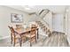 Dining area with a wooden table, decorative chairs, and a view of the staircase and adjacent living spaces at 7707 S Curtice Way # D, Littleton, CO 80120