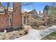 Charming townhome features a brick chimney and a cozy entrance with landscaped front yard at 7707 S Curtice Way # D, Littleton, CO 80120