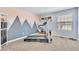Bright workout room with home gym equipment and decorative mountain wall art at 7707 S Curtice Way # D, Littleton, CO 80120