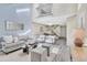 Bright living room featuring high ceilings, modern decor, and an open floor plan leading to the dining area at 7707 S Curtice Way # D, Littleton, CO 80120