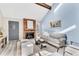 Comfortable living room with a brick fireplace, stylish furniture, and ample natural light creating a cozy atmosphere at 7707 S Curtice Way # D, Littleton, CO 80120