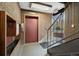 Brick walled entrance with elevator, stairs and doors leading to the outside at 1045 N Pennsylvania St # 303, Denver, CO 80203