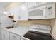 Close-up of a compact kitchen with modern appliances, white cabinets, and ample counter space at 1045 N Pennsylvania St # 303, Denver, CO 80203
