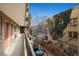 A balcony view in an apartment complex overlooking a small outdoor area with patio furniture at 1045 N Pennsylvania St # 303, Denver, CO 80203