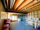 Unfinished basement with exposed beams, utilities, and walkout to the exterior at 750 Cougar Dr, Boulder, CO 80302