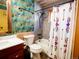 Bathroom features patterned wallpaper, wainscoting, shower with rainfall head, and decorative arrow-themed shower curtain at 750 Cougar Dr, Boulder, CO 80302