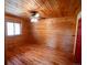 Cozy cabin bedroom with wood walls, hardwood floors, and a ceiling fan at 750 Cougar Dr, Boulder, CO 80302