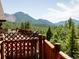 Wood deck with lattice railing overlooking mountain and forest views at 750 Cougar Dr, Boulder, CO 80302