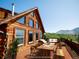 Charming cabin featuring a spacious deck with dining and seating, perfect for enjoying the surrounding mountain views at 750 Cougar Dr, Boulder, CO 80302