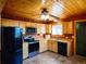 Cabin kitchen with wood cabinets, modern appliances, and tile floors at 750 Cougar Dr, Boulder, CO 80302