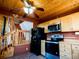 Cabin kitchen showcasing wood cabinets, modern appliances, and adjacent staircase at 750 Cougar Dr, Boulder, CO 80302