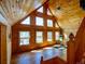 Cabin living room showcasing vaulted ceilings, wood walls, and natural light from multiple windows at 750 Cougar Dr, Boulder, CO 80302