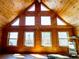 Cabin living room featuring a vaulted ceiling, wood walls, and natural light from multiple windows at 750 Cougar Dr, Boulder, CO 80302
