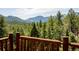 Expansive scenic view of the mountains and lush green forest from the wood deck at 750 Cougar Dr, Boulder, CO 80302