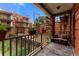Relaxing balcony features a seating area, wooden accents and a beautiful view of the surrounding neighborhood at 1356 N Pearl St # 109, Denver, CO 80203