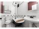 Elegant bathroom featuring a clawfoot tub, a classic sink, and white tiled walls at 1356 N Pearl St # 109, Denver, CO 80203