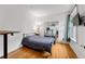 Well-lit bedroom has hardwood floors, a mirrored closet, and nice big windows at 1356 N Pearl St # 109, Denver, CO 80203