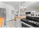 Bright kitchen features white cabinets, stainless steel appliances, and a cozy breakfast nook with butcher block counter at 1356 N Pearl St # 109, Denver, CO 80203