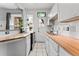 Modern kitchen featuring white cabinetry, wood counters, and a stained glass window in door at 1356 N Pearl St # 109, Denver, CO 80203