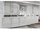 Well-lit laundry room features multiple new, white, front-load washing machines for tenant's convenience at 1356 N Pearl St # 109, Denver, CO 80203