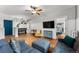 Living room with hardwood floors, blue sectional, and a view into the bedroom at 1356 N Pearl St # 109, Denver, CO 80203