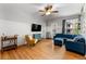 Living room with hardwood floors, a plush blue sectional, and bright natural light at 1356 N Pearl St # 109, Denver, CO 80203