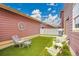 Cozy backyard featuring artificial turf, modern patio furniture, and a decorative tree of life wall decor at 600 Avalon Ave, Lafayette, CO 80026