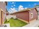 Private backyard featuring artificial turf, seating, modern siding, and a white fence for privacy at 600 Avalon Ave, Lafayette, CO 80026