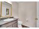 This half bathroom includes new fixtures, an oblong mirror, and wood look floors at 600 Avalon Ave, Lafayette, CO 80026
