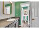 Open bathroom showcasing a sink and toilet with an emerald accent wall at 600 Avalon Ave, Lafayette, CO 80026