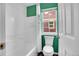 Bright bathroom featuring a shower-tub combination with white tile, a window, and modern fixtures at 600 Avalon Ave, Lafayette, CO 80026