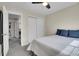 Bedroom featuring neutral walls, blue pillows on a bed, carpet, and access to a closet and hallway at 600 Avalon Ave, Lafayette, CO 80026