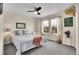 This bedroom has a ceiling fan, two large windows, and neutral colored carpet at 600 Avalon Ave, Lafayette, CO 80026