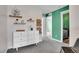 Light filled bedroom with shelves, decorative baskets, and a glimpse into the en-suite bathroom at 600 Avalon Ave, Lafayette, CO 80026
