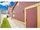 Side exterior featuring modern siding, an exterior door, and artifical turf along the side of the house at 600 Avalon Ave, Lafayette, CO 80026