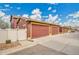 Detached garages with modern doors, split rail fences, and plenty of paved parking at 600 Avalon Ave, Lafayette, CO 80026
