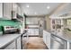 This kitchen features stainless steel appliances, granite countertops, and light wood flooring at 600 Avalon Ave, Lafayette, CO 80026