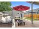 Cozy backyard featuring a deck with outdoor seating, a fire pit, and a well-kept lawn at 3937 Osceola St, Denver, CO 80212
