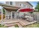 Charming backyard deck with comfortable seating, a grill, and a vibrant red umbrella at 3937 Osceola St, Denver, CO 80212