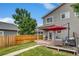 Backyard with a patio, grill, and a lovely red umbrella, perfect for outdoor entertaining at 3937 Osceola St, Denver, CO 80212