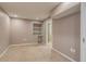 Finished basement with neutral carpeting, built in shelves, and access to the bathroom at 3937 Osceola St, Denver, CO 80212