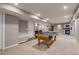 Open basement layout with pool table, wet bar, fireplace, and recessed lighting at 3937 Osceola St, Denver, CO 80212