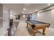 Basement with a pool table, wet bar, and a cozy fireplace for a relaxing recreation space at 3937 Osceola St, Denver, CO 80212
