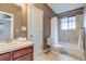 Bathroom featuring vanity, toilet, tub with shower and tiled floor at 3937 Osceola St, Denver, CO 80212