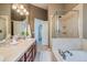 Modern bathroom showcasing a walk-in shower, soaking tub, double vanity, and contemporary fixtures at 3937 Osceola St, Denver, CO 80212