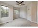 Bedroom featuring neutral paint, neutral carpet, two large windows and a ceiling fan with light at 3937 Osceola St, Denver, CO 80212