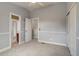Bedroom featuring neutral carpeting, white trim, closet and a view to the hallway and bathroom at 3937 Osceola St, Denver, CO 80212